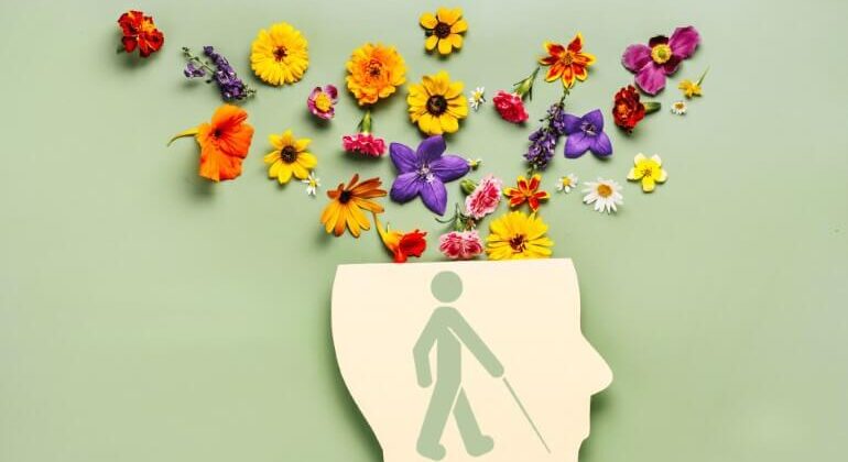 Desenho de cabeça aberta saindo flores e ao centro ícone de pessoa com deficiência visual.